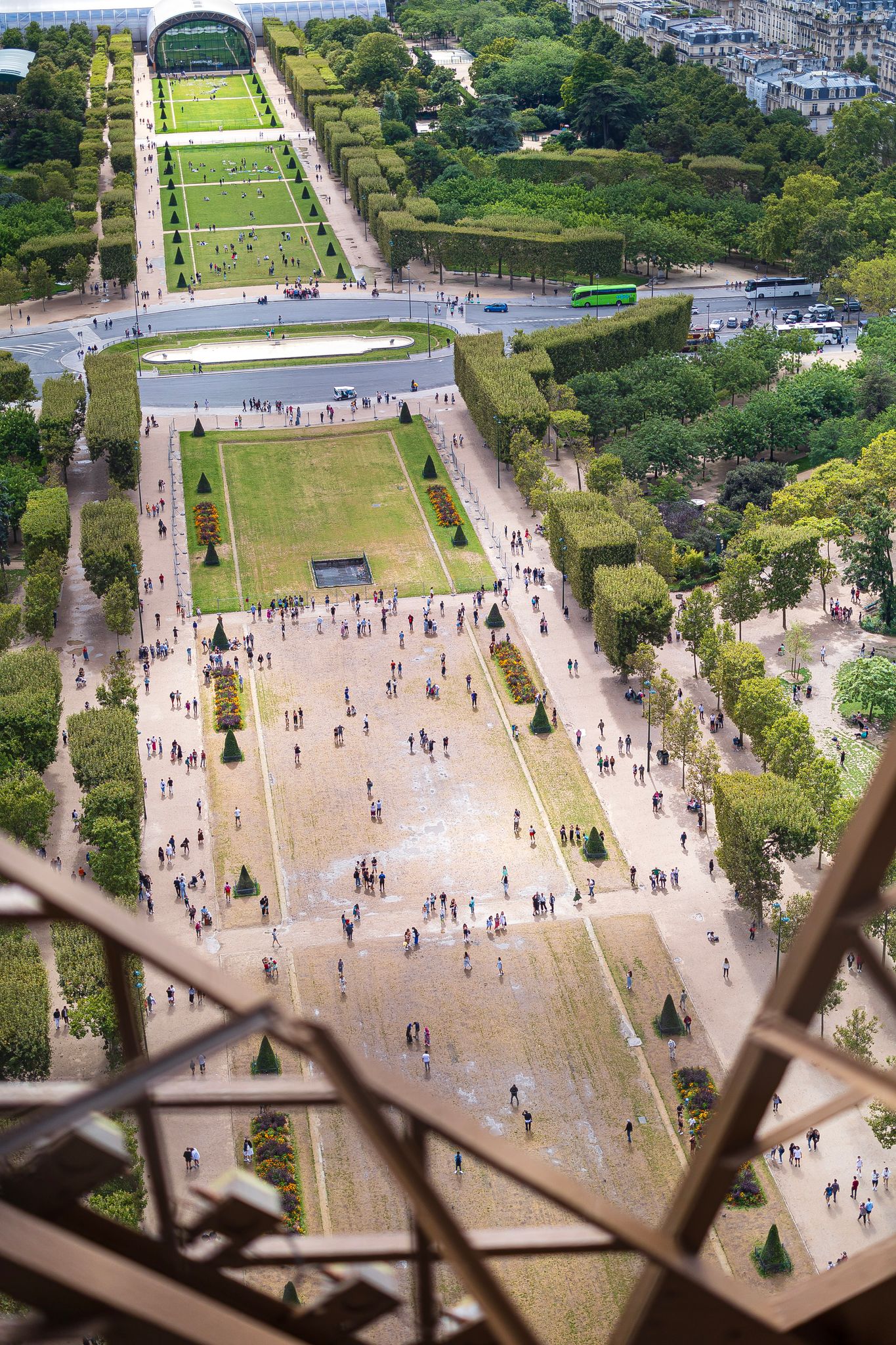 People gather at the Champ de Mars, a park just next to the Eiffel Tower. Taken from the Eiffel Tower elevator