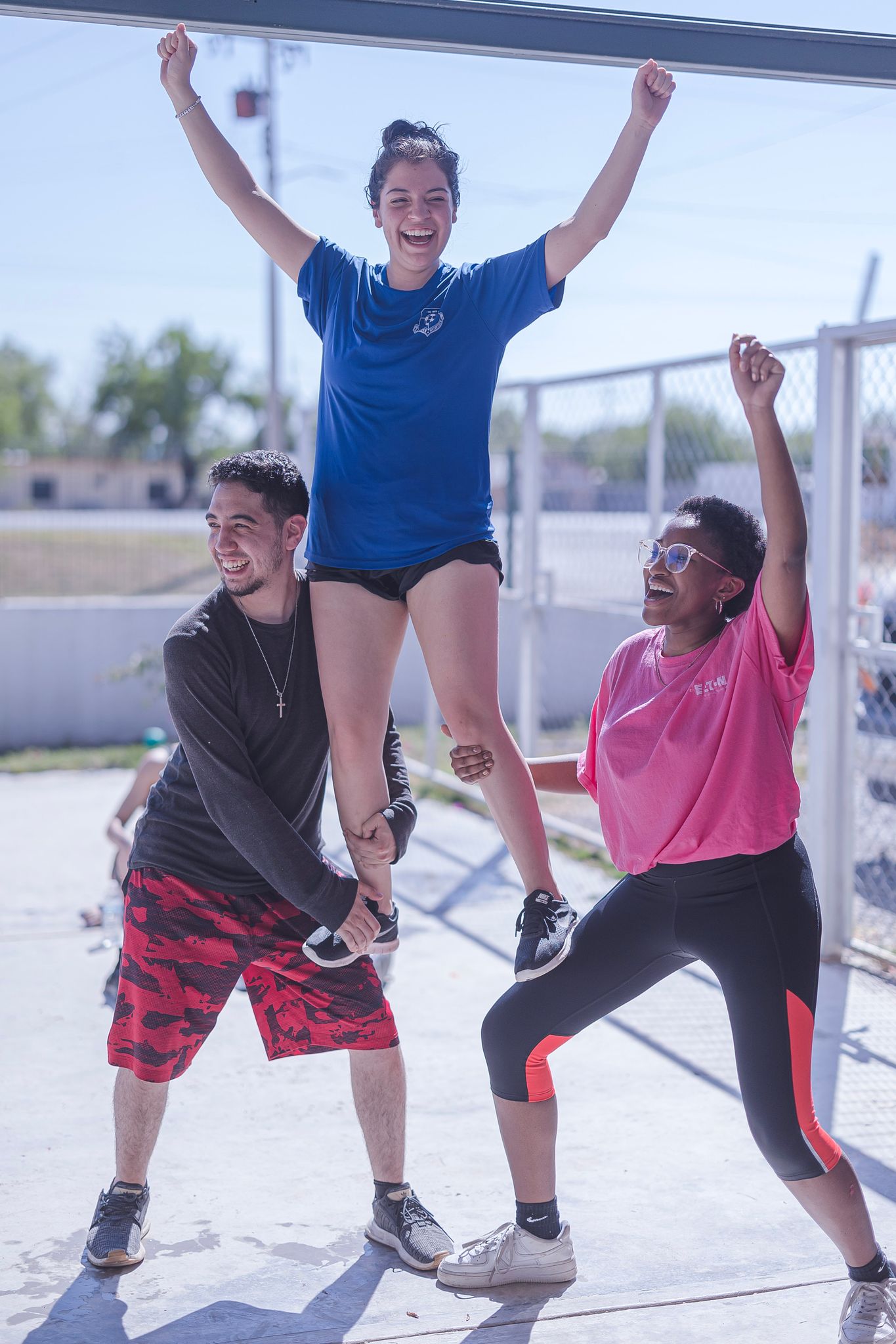 A team of volunteers visiting an orphanage show off their cheerleading skills