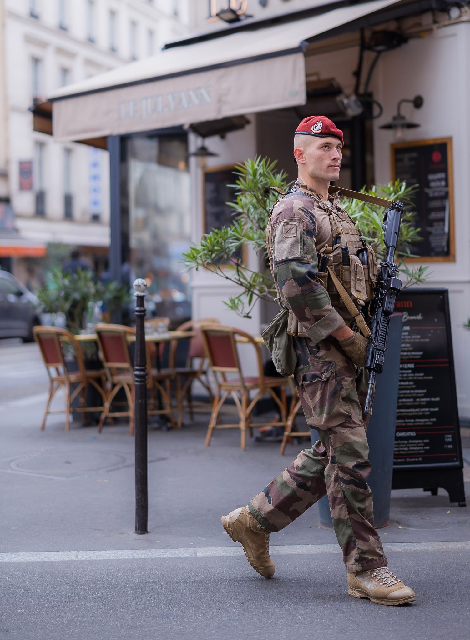 A member of a French paratrooper regiment patrols a Parisian alleyway