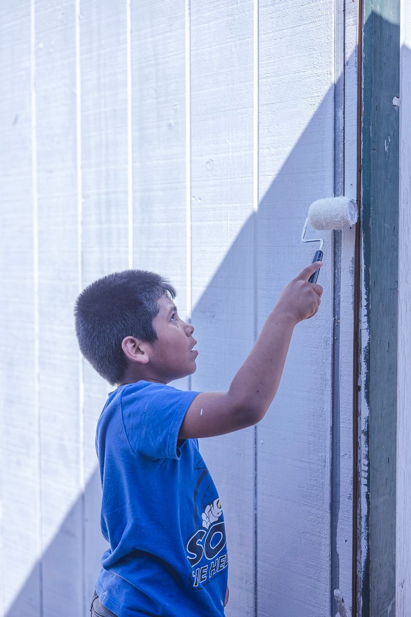 A child repaints the walls of an orphanage's dining hall