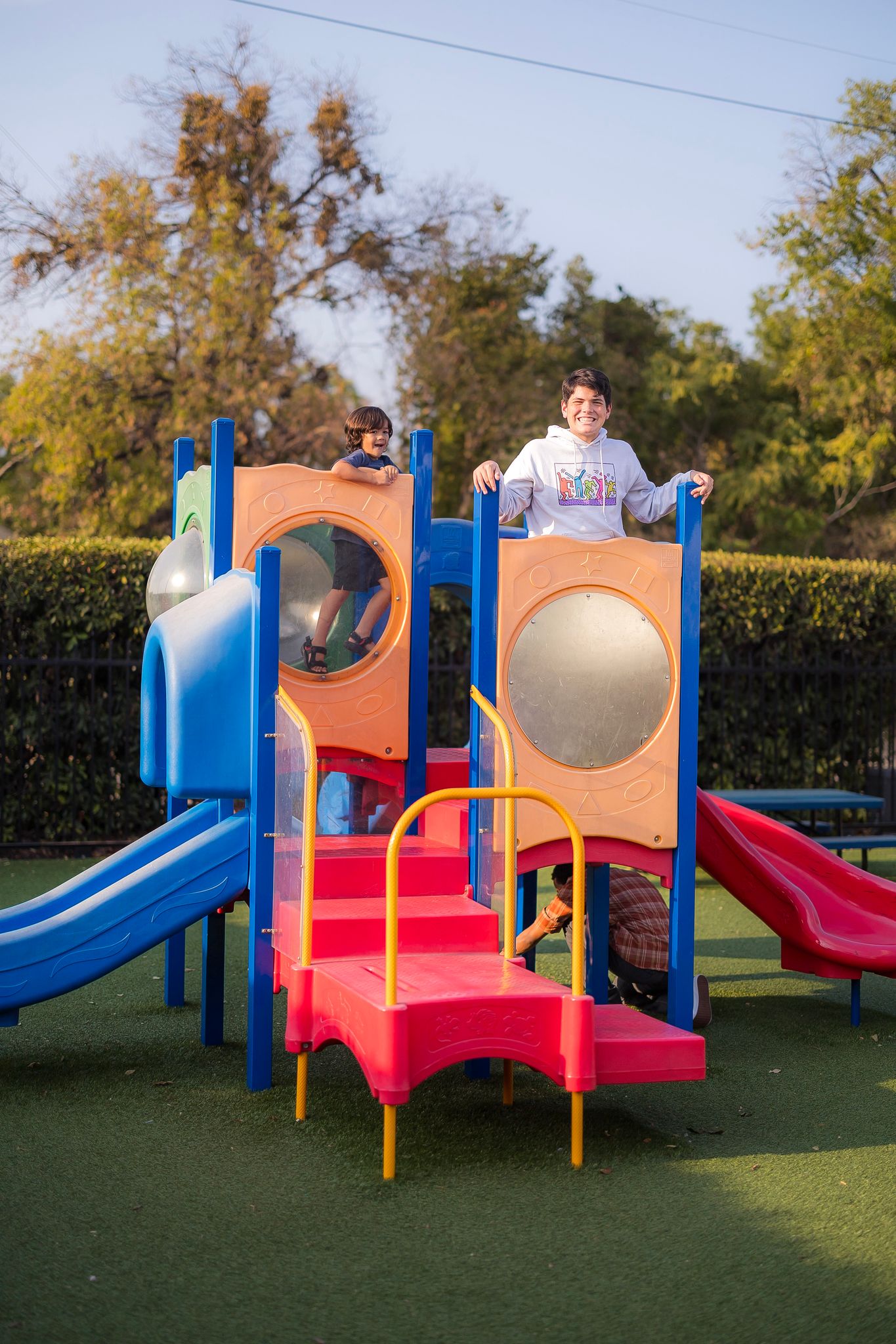 An actor plays on a playground after a fire alarm went off on the set of a film